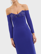 Stunning ultramarine blue off-the-shoulder gown, featuring a graceful design that accentuates the figure beautifully.