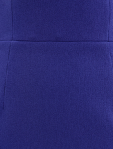 Off-the-shoulder ultramarine blue gown, elegantly draped, showcasing a flowing silhouette and sophisticated design.