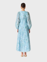 Back view of a woman in a blue floral dress, showcasing the Faye Maxi Dress in Blue Multi.