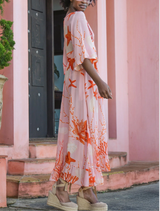 Vibrant pink shell dress adorned with a fiery design, ideal for those looking to stand out in a stylish outfit.