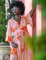 Pink shell dress with a fitted silhouette, featuring a vibrant fire-themed design, perfect for a bold fashion statement.