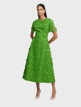 Short-sleeved green dress made of lace, showcasing a delicate and fashionable design.