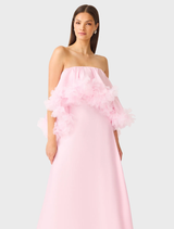 Elegant strapless gown in pale pink, featuring a fitted bodice and a flowing skirt, ideal for special events.