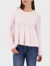 Light rose flared sweater with a relaxed fit, featuring long sleeves and a stylish, flowing silhouette.