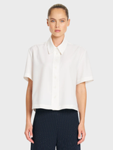 Chalk-colored Flex Weave Crop Shirt with a classic collar and button front, crafted from a minimalist twill weave material.