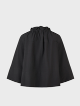A black flip jacket laid flat, highlighting its modern style and versatile use.