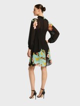 The Julia Dress is a black garment featuring a dark ink floral design, combining elegance with a touch of nature
