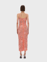 Francesca's peach flower gown, showcasing beautiful floral accents and a soft, flowing design, displayed on a dress form.