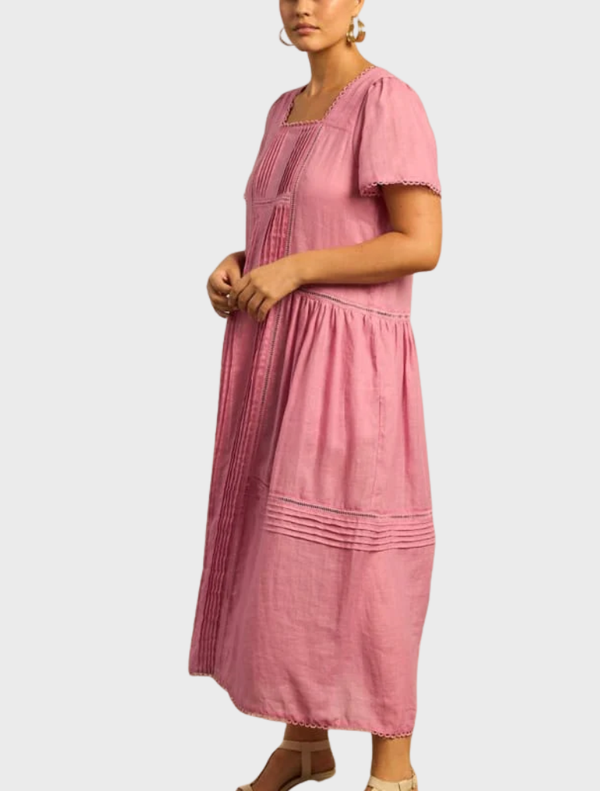 The Skyscape Dress features a colorful design inspired by the sky, blending blues and pinks for a whimsical look.
