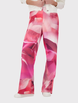 Wide-leg trousers featuring a vibrant floral gradient print and a comfortable stretchy waistband for ease of movement.