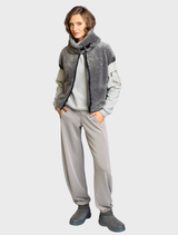 Fluffy pullover in a smoke hue, showcasing its soft fabric, displayed on a hanger against a simple backdrop.