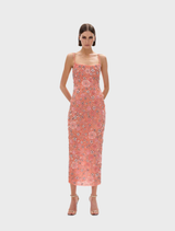 Peach Francesca flower gown displayed on a mannequin, featuring delicate floral patterns and flowing fabric.