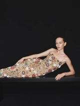 The Francesca Gown in Gold showcases a shimmering column silhouette, intricately embellished with sequins and stones.