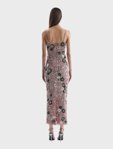 The Rosewater Francesca Gown features exquisite craftsmanship, a form-fitting design, and a dramatic back split for unforgettable style.