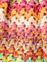 Amalia Petite Gathered Clutch, a stylish multi-colored woven clutch bag with a unique gathered texture and design.