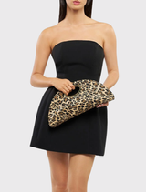 Geena Straw Clutch Bag features a leopard pattern, half-moon shape, woven fabric, detachable chain, and magnetic closure.