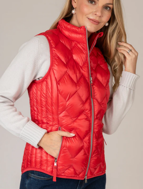 Women's red puffy vest made from lightweight, breathable material, ideal for layering in cooler weather.