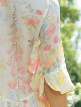 A woman models the Get Shirty Dress, wearing a floral shirt and a stylish necklace.