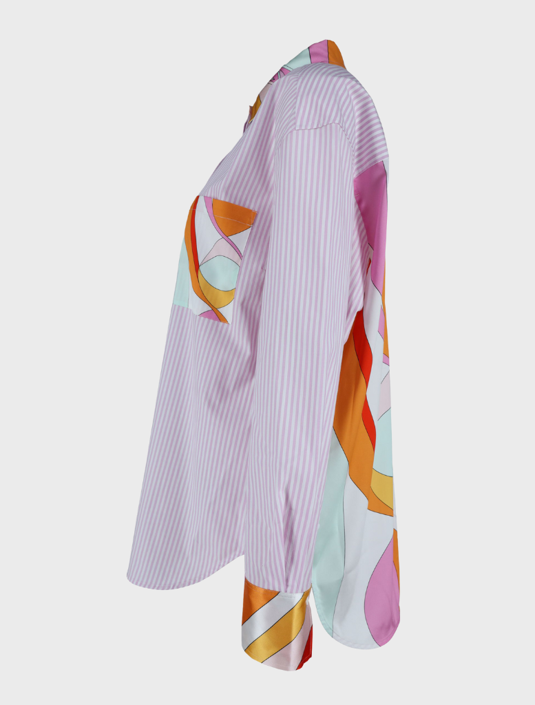 A colorful patterned blouse titled "Gigi Multi," showcasing a lively design on a light background.