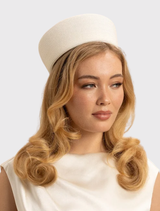 Ivory white Gillian Pillbox Hat by Morgan & Taylor, featuring a classic shape and minimalist design for elegant occasions.