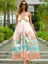 A vibrant sunset-colored dress with a bow detail at the waist, showcasing a stylish and elegant design.
