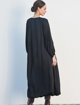 Chic black dress with shimmering accents, ideal for formal events, offering a flattering fit and eye-catching design.