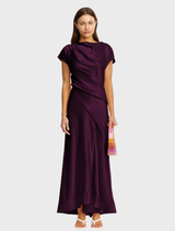 A long, flowing maxi dress in a rich fig color, featuring a relaxed fit and elegant design.