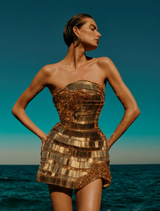 Elegant gold Ariel Mini Dress with a stylish cut, ideal for parties or formal events, showcasing a chic and modern look.