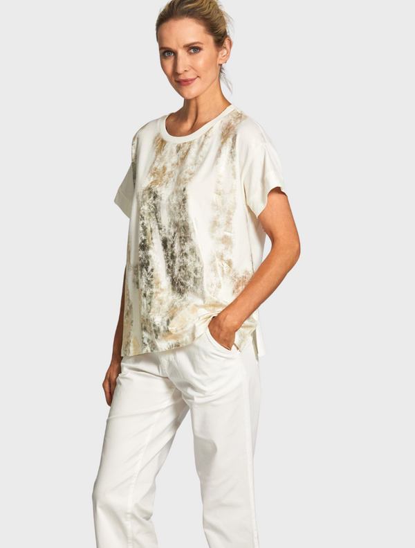 A stylish white top featuring a colorful tie-dye design, highlighting its artistic fabric texture.