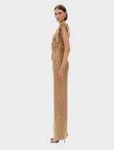Stunning gold Lani gown draped elegantly, highlighting its luxurious fabric and graceful lines.