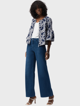 A woman wearing medium blue wide leg jeans, highlighting the trendy Goldie denim style.