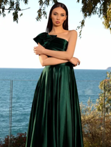A deep emerald gown draped elegantly, emphasizing its flowing silhouette and vibrant color.