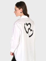 Off white and black buttoned shirt with a graphic design, presented on a hanger.