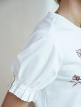 Foil & Flourish T-Shirt in white, adorned with a chic foil embellishment.