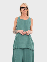 A grass-colored tank top hanging on a hanger, featuring a simple and modern cut.