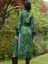 Stylish green floral dress for winter, featuring a fitted top and a flowing skirt, suitable for holiday gatherings.