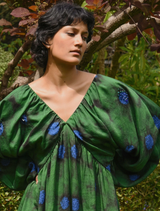 Elegant green floral dress with puff sleeves and a cinched waist, ideal for outdoor events or casual gatherings.