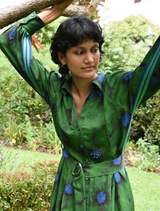 Elegant green floral dress designed for winter, showcasing a fitted silhouette and a graceful, flowing skirt.