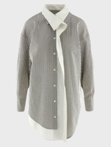 A stylish grey Mira blouse hanging, highlighting its modern cut and soft material.