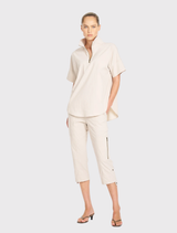 Mela Purdie's Half Zip Shirt in Hay, featuring a zip collar, short sleeves, and lightweight, breathable cotton blend fabric.