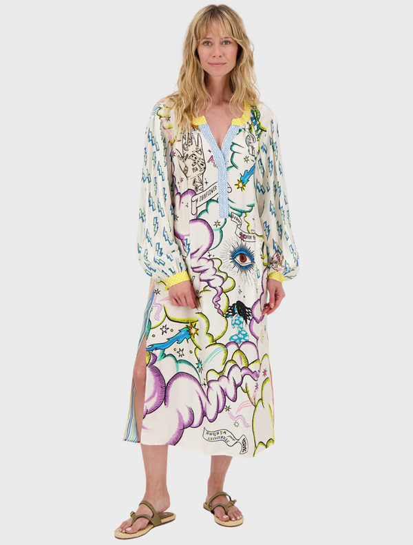  A woman in a vibrant, patterned dress stands confidently, showcasing colorful designs that reflect her unique style.