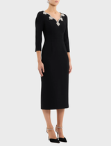 Elegant black midi dress with long sleeves, designed for a sophisticated look, perfect for both casual and formal events.