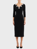 Black long-sleeve midi dress featuring a sleek design and elegant silhouette, suitable for various occasions.