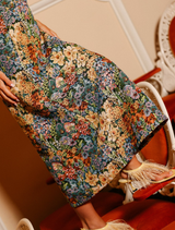 The Harper Dress showcases a strapless column style in floral jacquard, perfect for weddings and special occasions.
