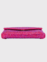 This stunning fuchsia shoulder bag, adorned with crystal embellishments, includes a magnetic closure and a slip pocket, making it appropriate for red carpet affairs.