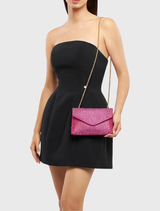 Chic fuchsia Hattie Crystal Bag with crystal details, magnetic closure, and shoulder chain, designed for glamorous evening wear.