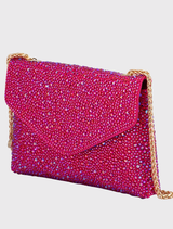 Glamorous fuchsia shoulder bag with crystal embellishments, magnetic closure, and a slip pocket, suitable for red carpet events.