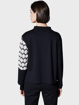 A hexagonal jacquard knit in ecru and black, displaying a modern geometric pattern suitable for various fashion applications.