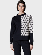 Hexagonal jacquard knit fabric in ecru and black, showcasing a geometric pattern with contrasting colors.