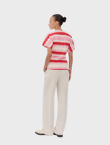 Fitted UrbanMD T-shirt in hibiscus peach with red and pink stripes, short sleeves, round neckline, and ruched waist detail.
